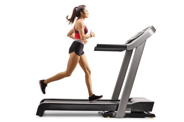 junge sportliche sportlerin läuft auf einem laufband - treadmill gym isolated running stock-fotos und bilder