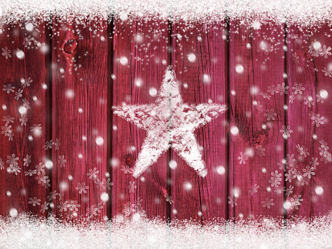Vintage Christmas winter holiday snow star background with falling snowflakes around on wooden texture with snow frame as a greeting or voucher card