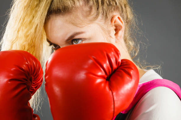 istock Angry woman wearing boxing gloves 1175241857