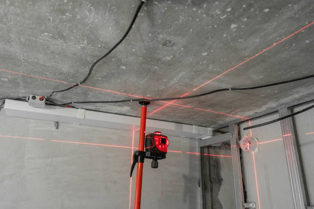 Laser measurement during renovation. Construction tools and equipment. Red laser light lines for level measure. Laser measurement during renovation. Construction tools and equipment. Red laser light lines for level measure measuring a room stock pictures, royalty-free photos & images