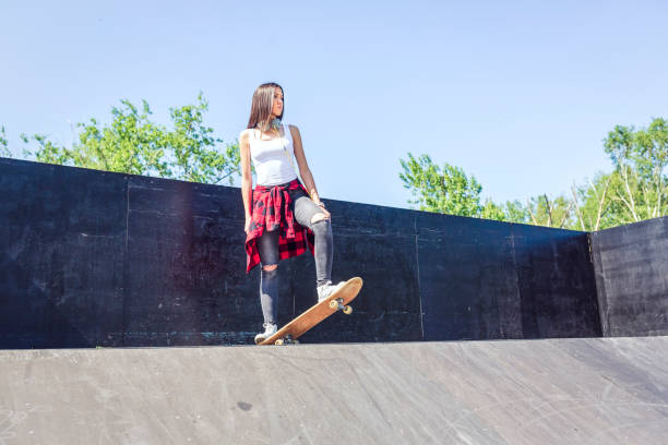 istock Girl skateboarder in skateboard park 1175242869