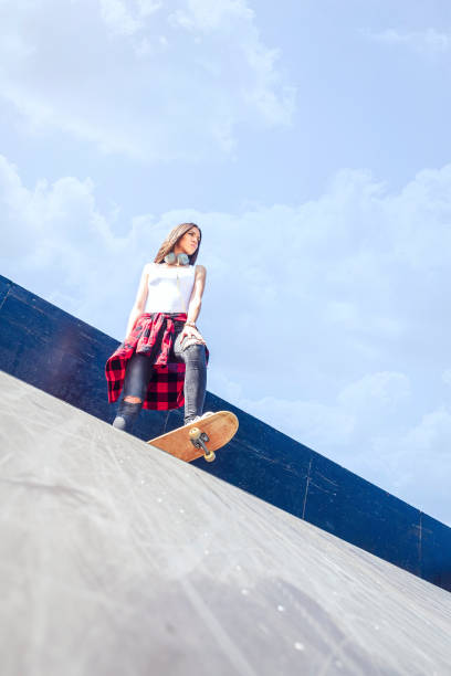 istock Girl skateboarder in skateboard park 1175242946