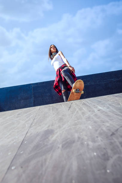 istock Girl skateboarder in skateboard park 1175243000