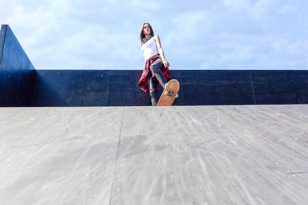 istock Girl skateboarder in skateboard park 1175243067