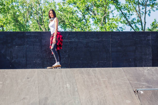 istock Girl skateboarder in skateboard park 1175243225