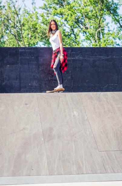 istock Girl skateboarder in skateboard park 1175243320