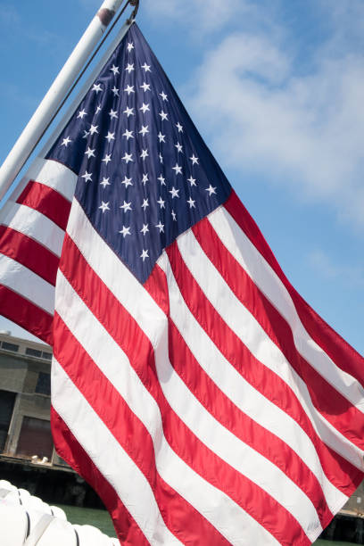 istock Close up waving US flag set against a blue sky. 1175245638