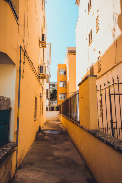 istock orange buildings in a street at majorca 1175246968