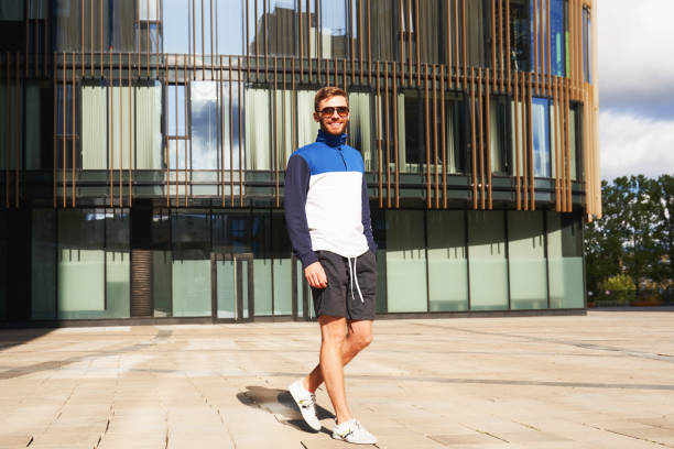 istock Guy walking among modern buildings in large city 1175247685