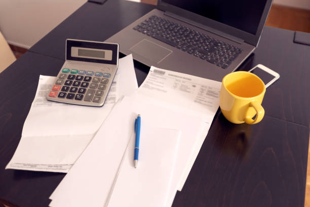 istock business man doing account about expenses at home, 1175248581
