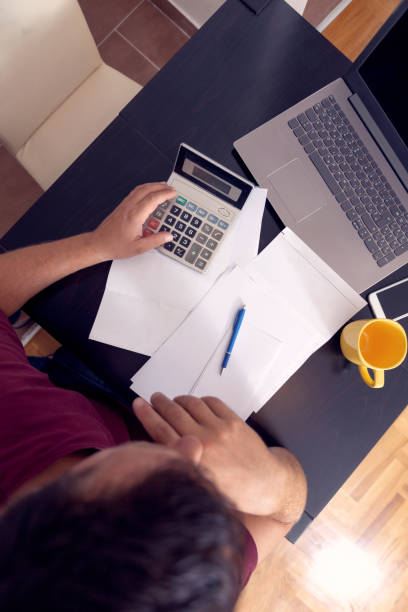 business man doing account about expenses at home,