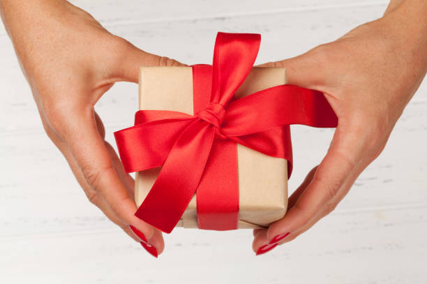 istock Woman hands holding gift box 1175248866