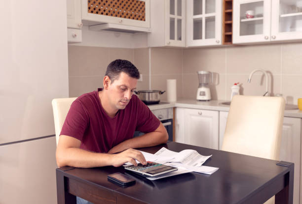 istock business man doing account about expenses at home, 1175249133