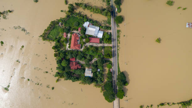 Aerial top view of Flooded rice paddies and the village, View from above shot by drone stock photo