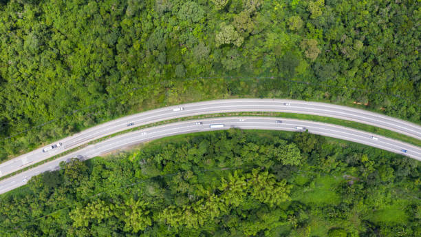 istock Aerial top view of a provincial road passing through a forest background 1175250486