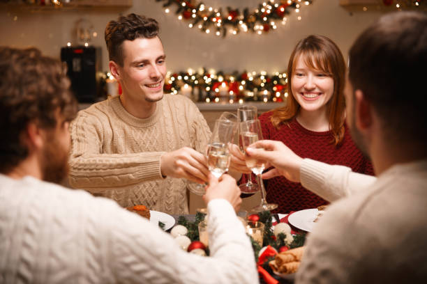 istock Happy friends clinking wine glasses at christmas table 1175250537
