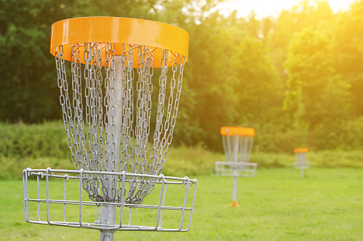 Disc golf basket in the park.