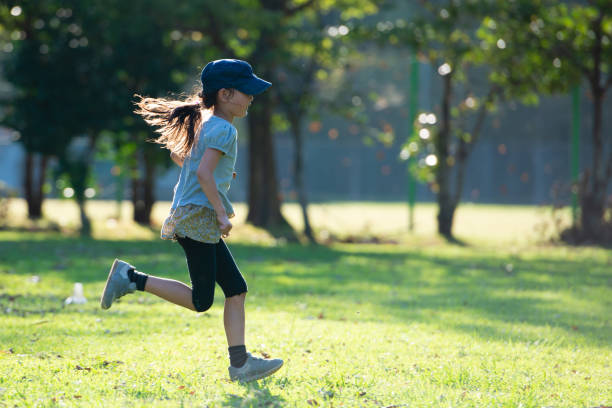 girl running in the park - healthy lifestyle nature sports shoe childhood imagens e fotografias de stock
