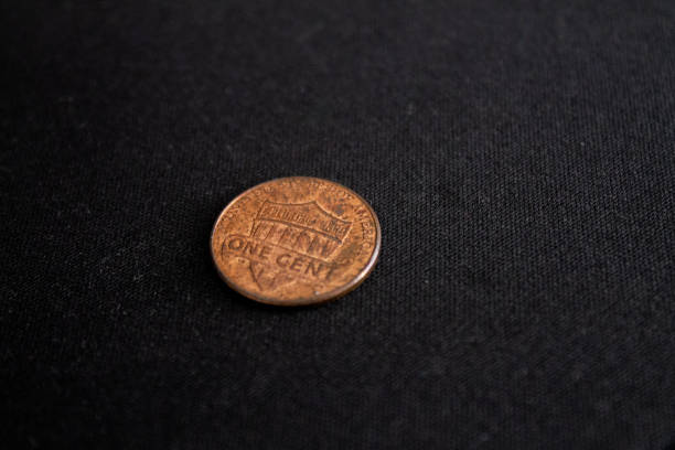 istock One Cent of a Dollar Coin over a dark table 1175252489