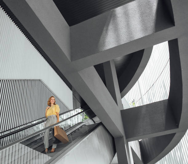istock Woman Standing on Shopping Mall Stairs 1175252525