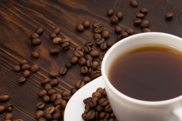 istock Cup of coffee surrounded by coffee beans. 1175254643