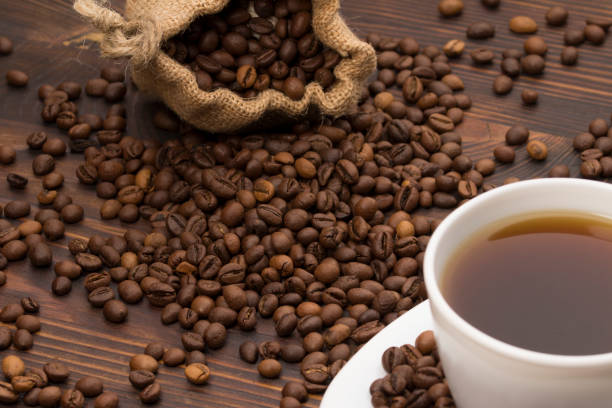 istock Coffee cup with coffee bag on wooden table. coffeee beans 1175254671