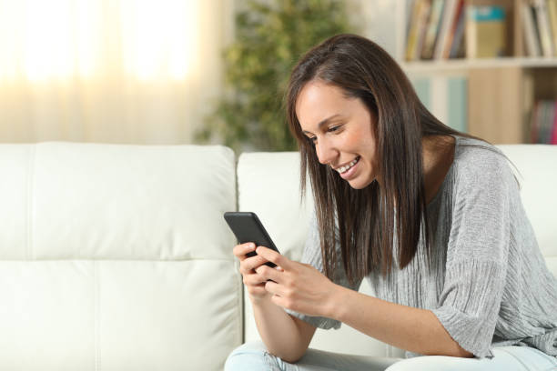 istock Happy woman at home using a smart phone 1175255512