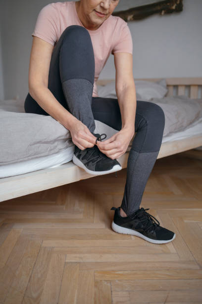 istock Woman Tying a Sneaker 1175258509