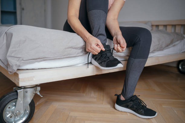 istock Woman Tying a Sneaker 1175258533