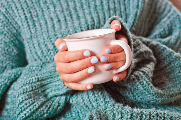 istock Female hands holding hot cup of coffee or tea. 1175259065
