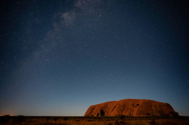 The Night Sky Over Uluru stock photo