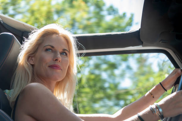 istock Woman driver On Road Trip In Convertible Car 1175261105