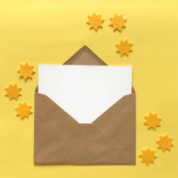 istock Flat lay of blank postcard and envelope with copy space for card mockups, invitations, backgrounds. Small yellow felt stars for crafting, DIY, design, decoration. Stationery products mock up. 1175262819