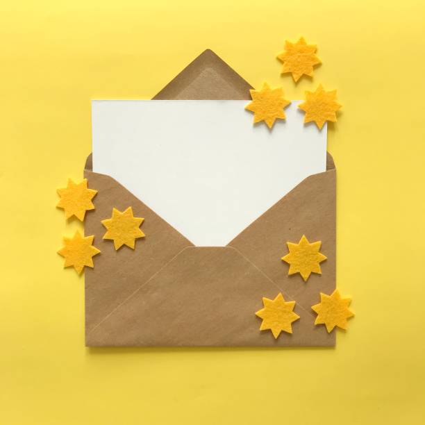 istock Flat lay of blank postcard and envelope with copy space for card mockups, invitations, backgrounds. Small yellow felt stars for crafting, DIY, design, decoration. Stationery products mock up. 1175262828