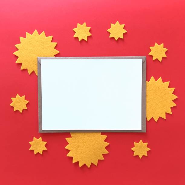 istock Blank postcard with brown craft paper envelope on red background, composition with sunny yellow felt stars for stationery mock ups, postcards, letters, greeting cards, prints, invitations, flyers. 1175262904