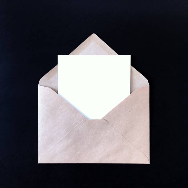 istock Blank postcard and craft envelope on black background. Mock up for greeting cards, stationery, postcards, prints, flyers, invitations, designs, letterhead. Isolated note card photography mockup. 1175263047