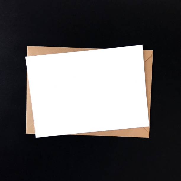 istock Blank postcard and craft envelope on black background. Mock up for greeting cards, stationery, postcards, prints, flyers, invitations, designs, letterhead. Isolated note card photography mockup. 1175263098