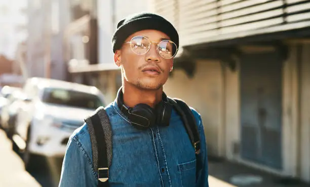 Cropped shot of a handsome young man walking through the city