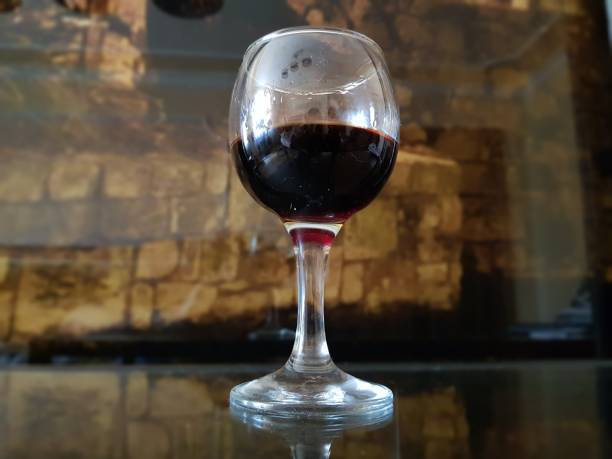istock Glass of wine on a stone wall background. 1175266715