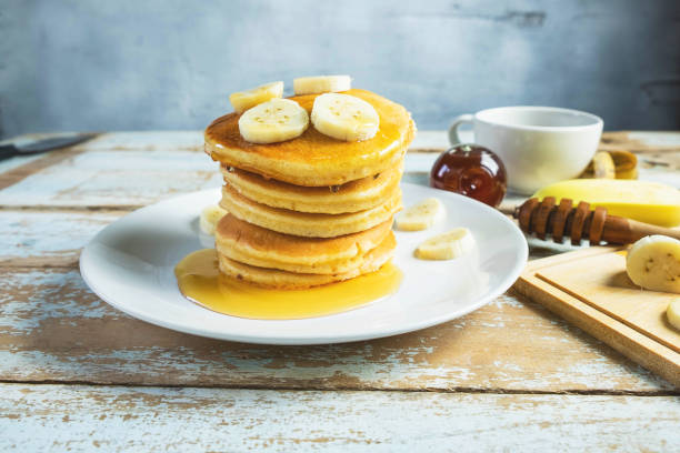 istock Pancakes topped with honey and bananas on the table 1175267114