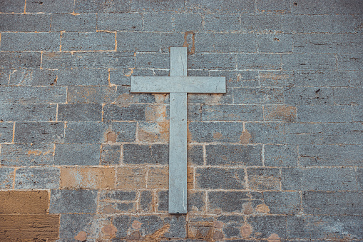 christian cross at grey marble facade