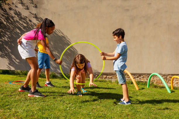 istock Girl jump through the hula ring in active game 1175269670