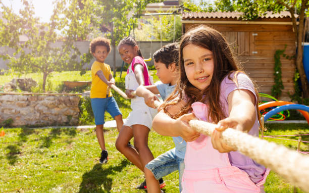 istock Rope pulling game portrait of kids in summer camp 1175269722