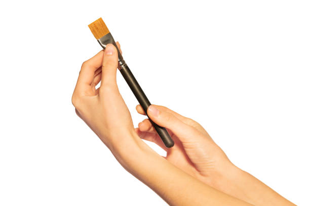 istock Make-up artist hands holding shader brush on white 1175270570