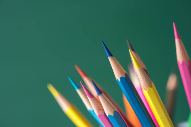istock Close-Up Of Multi Colored Pencils Against Green Background 1175273440