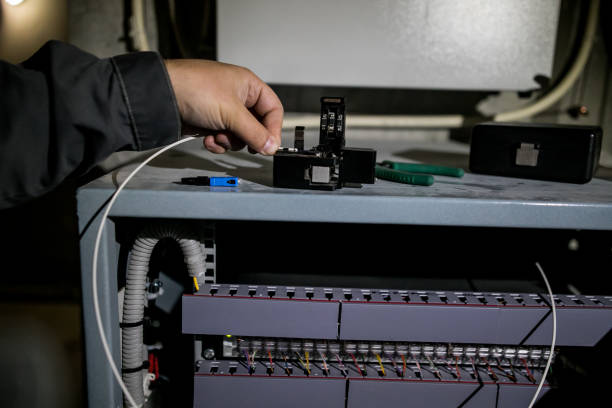 istock The technician attaching fiber optic on the Optical Distribution Frame. Man working in network server room with fiber optic hub for digital communications and internet. 1175273789