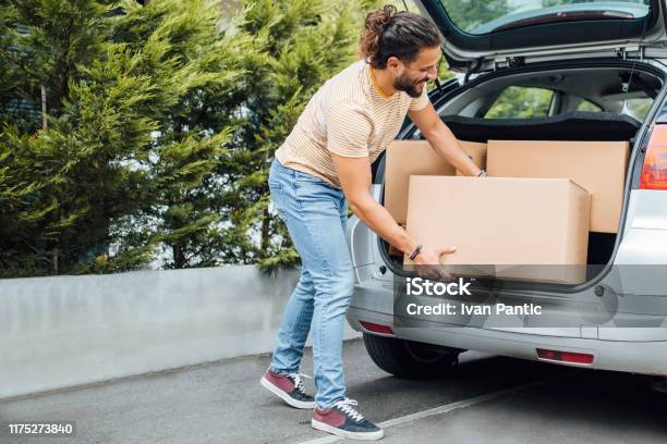 Young Millennial Man Moving Away Stock Photo - Download Image Now - Car, Box - Container, Car Trunk