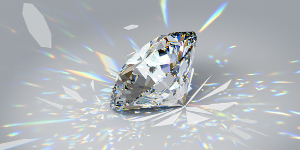 Side view of a round cut diamond reflecting highly dispersed rainbow-colored rays of light