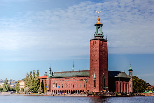 Stockholm, Sweden. Scenic Skyline View Of Famous Tower Of Stockholm City Hall. Building Of Municipal Council Stands On Eastern Tip Of Kungsholmen Island. Famous And Popular Place at sunny summer day.