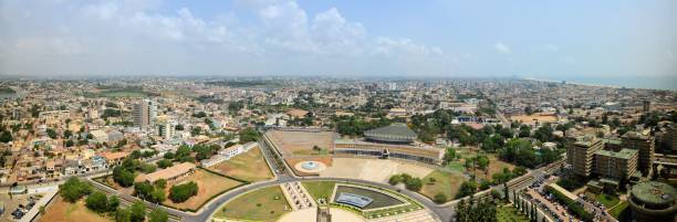 Lome skyline, panoramic view - Lomé, Togo Lomé, Togo: cityscape of the Togolese capital - skyline seen from above the main square (Place de l'Independance) and the government area, with the Atlantic Ocean on the top right togo stock pictures, royalty-free photos & images